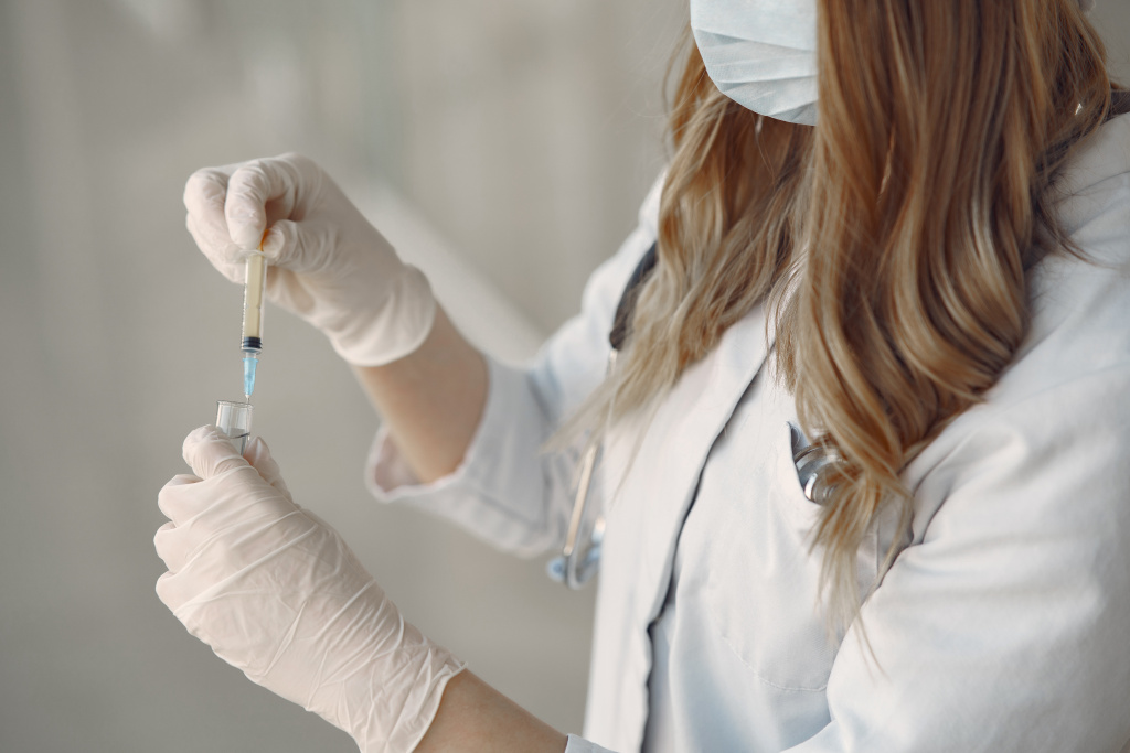 woman-mask-uniform-holding-syringe-her-hands.jpg